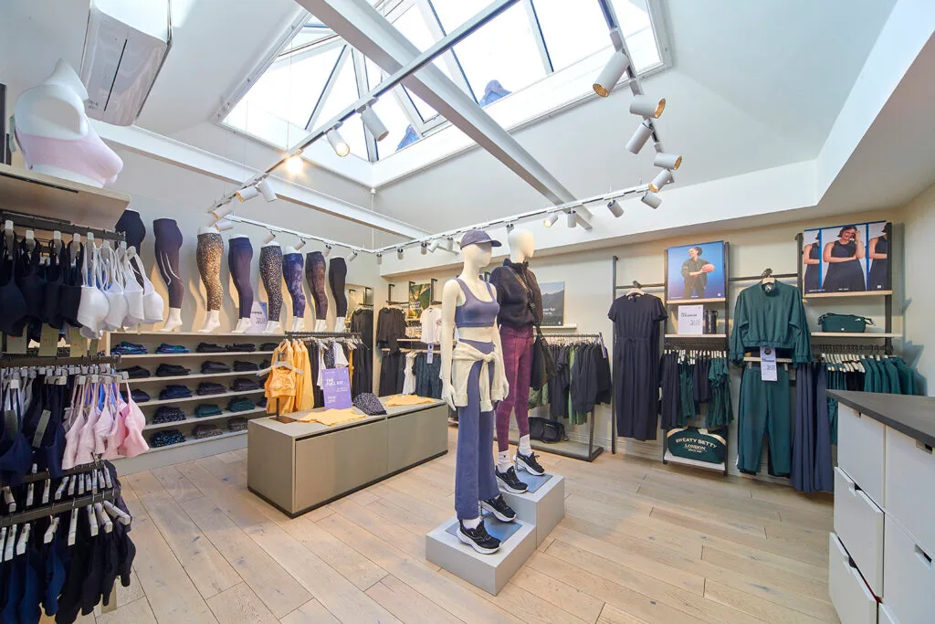 View of internal retail space. A room clothing racks and sportwear clothing on display